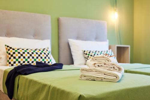 a couple of beds with towels on top of them at Napodano Apartments - Napoli Salerno in Sant'Egidio del Monte Albino