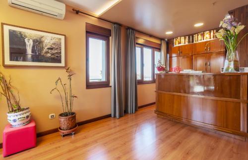 an empty waiting room with a reception desk in a room at La Colina in Gijón