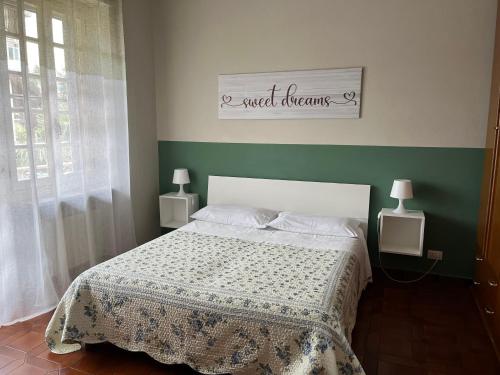 a bedroom with a bed with a green wall at L’ulivo in Ciriè