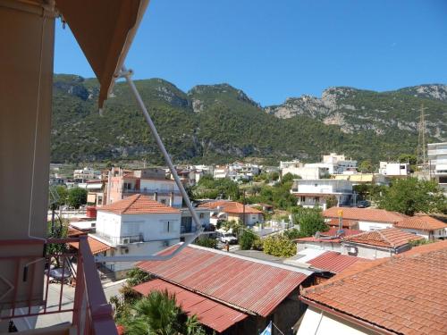 a view of a city with mountains in the background at Angela's Apartment with beautiful balcony view in Agios Konstantinos Fthiotida
