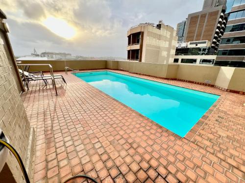 a swimming pool on the roof of a building at Kingsleigh Apartments Sydney in Sydney