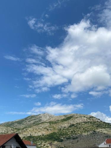 a mountain under a blue sky with clouds at Nina in Ivanica