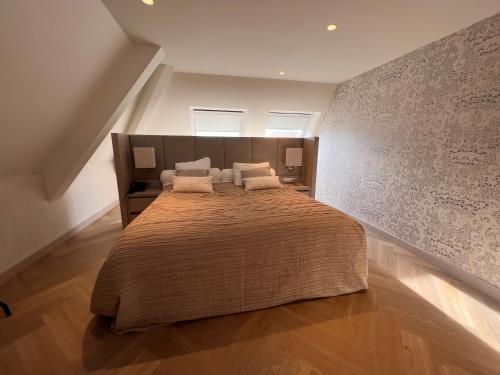 a bedroom with a large bed with two pillows at Van der Valk Hotel Hengelo in Hengelo
