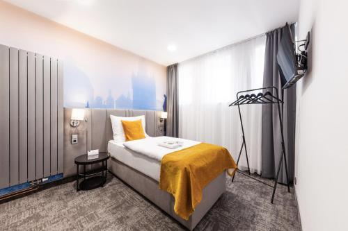 a hotel room with a bed and a camera at A1 Royal Plaza in Prague
