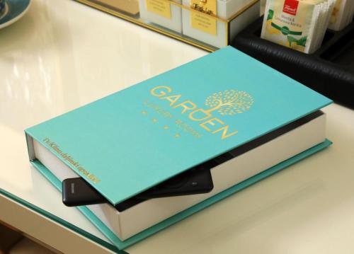 two books stacked on top of each other on a counter at Garden Luxury Rooms in Split