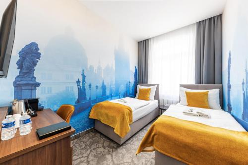 a hotel room with two beds and a mural at A1 Royal Plaza in Prague