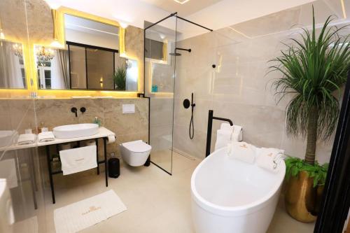 a bathroom with a toilet and a sink and a shower at Garden Luxury Rooms in Split