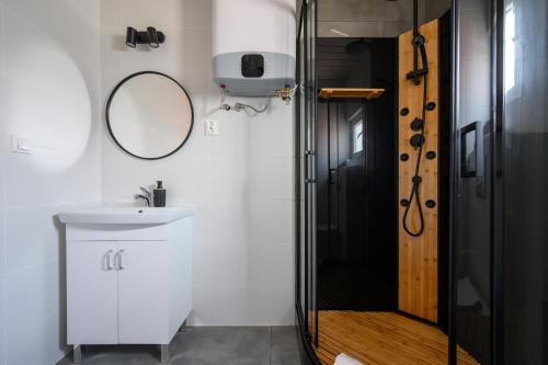a bathroom with a sink and a shower at RESORT za lasem II in Jarosławiec
