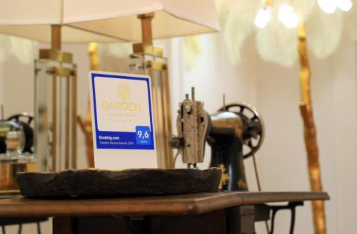 a sign on top of a table with a sewing machine at Garden Luxury Rooms in Split