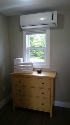 a dresser in a room with a window at North Rustico Harbour Inn in North Rustico
