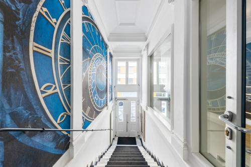 a hallway with blue and white walls and stairs at A1 Royal Plaza in Prague