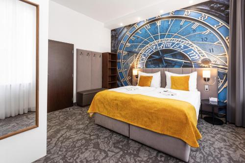 a hotel room with a large bed and a ferris wheel mural at A1 Royal Plaza in Prague