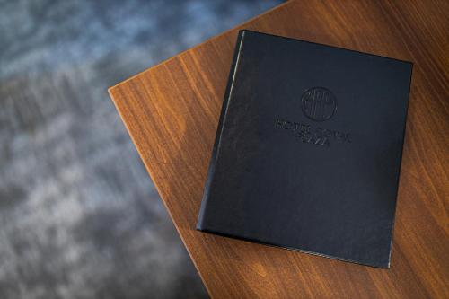 a book sitting on top of a wooden table at A1 Royal Plaza in Prague