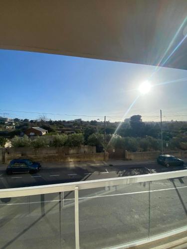 a view of a parking lot from a window at An immaculate 3 bedroom apartment in Gudja in Gudja