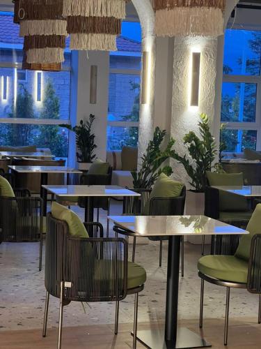 a restaurant with tables and chairs and lights at Уютный коттедж на берегу Иссык-Куля, Киргизия in Chok-Tal