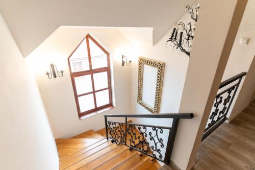 a staircase with a window and a mirror at Natura vendégház in Abaújvár