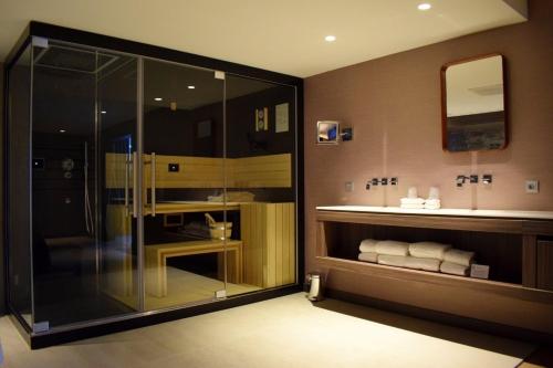 a bathroom with a shower and a sink at Van der Valk Hotel Hengelo in Hengelo