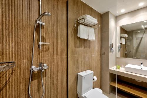 a bathroom with a shower and a toilet and a sink at White Olive Premium Laganas in Laganas