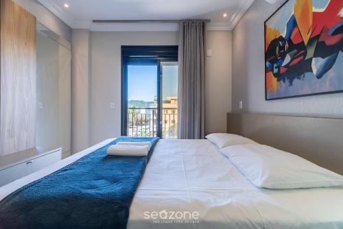 En eller flere senge i et værelse på UML - Apartamentos quadra mar em Bombinhas