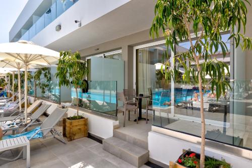 a house with a pool and a swimming pool at White Olive Premium Laganas in Laganas