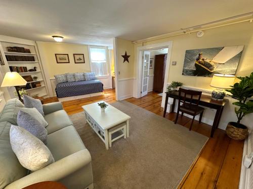 a living room with a couch and a table at Entire Historic 5 Bed 5 Bath Inn Sleeps 17 in Newport