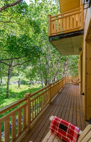 a deck on a cabin with a blanket on it at 1740 Boutique Hotel Kazbegi in Stepantsminda