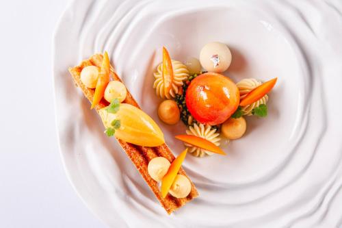 a white plate with some food on it at Relais et Châteaux Thalasso & Spa Ile de la Lagune in Saint-Cyprien