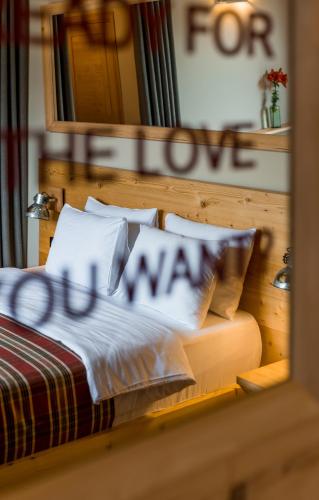 a bedroom with a bed with a sign that says marry at 1740 Boutique Hotel Kazbegi in Stepantsminda