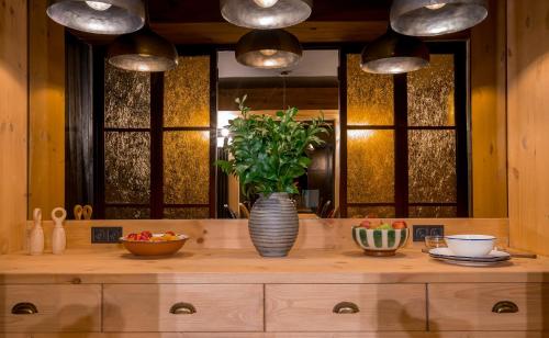 a kitchen counter with a vase with a plant on it at 1740 Boutique Hotel Kazbegi in Stepantsminda