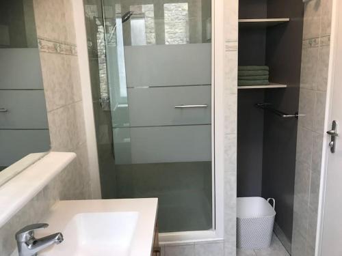 a bathroom with a sink and a glass shower at La Maison de la Cour in Avon