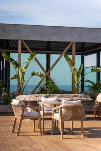 a table and chairs on a patio with a view at Root Redrock Yalıkavak in Yalıkavak