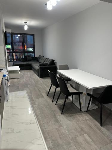 a living room with a white table and chairs at Апартамент - Весела улица in Sozopol