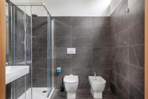 a bathroom with a shower and a toilet and a sink at B&B Hotel Pomezia Roma in Pomezia