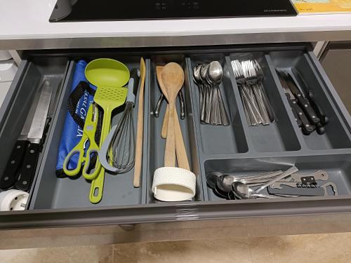 a drawer filled with utensils in a kitchen at L'étoile de Zakiel in Cambayrac