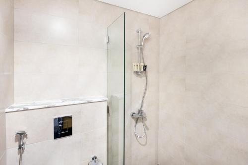 a shower with a glass door in a bathroom at Cozy 1 BR apartment in Dubai near Burj khalifa in Dubai