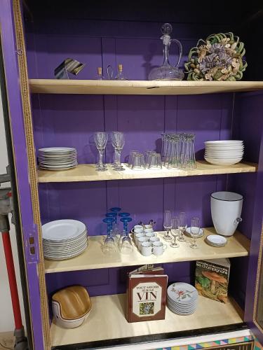 a cabinet filled with plates and glasses and dishes at L'étoile de Zakiel in Cambayrac