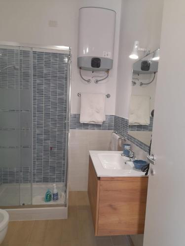 a bathroom with a sink and a shower at Beach Rooms 1 Self Check-in in Alghero