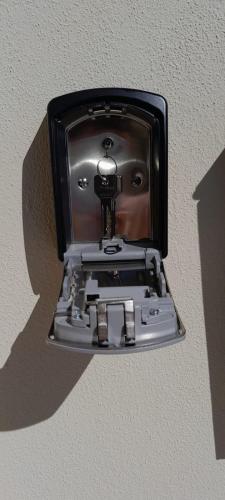 a light attached to a wall with a camera at Beach Rooms 1 Self Check-in in Alghero
