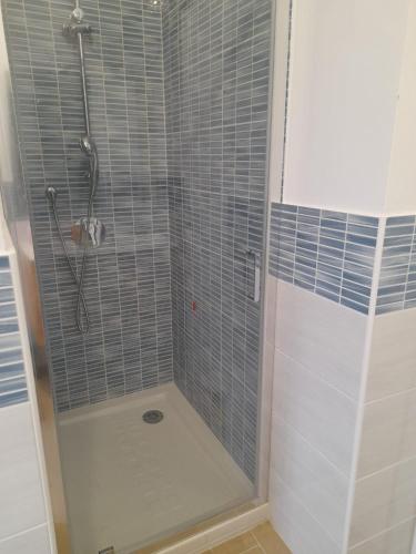 a bathroom with a shower with a glass door at Beach Rooms 1 Self Check-in in Alghero