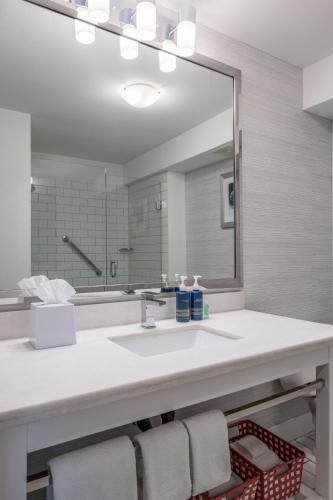 a bathroom with a sink and a large mirror at Four Points by Sheraton Victoria Gateway in Victoria