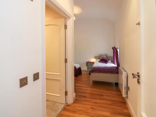 a hallway with a bedroom with a bed in it at The Farm Cottage in Athy