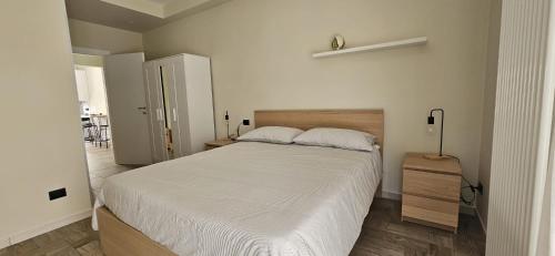 a bedroom with a large bed with white sheets at B&B Via Roma in Gioia del Colle