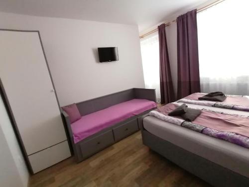 a bedroom with two beds and a mirror at Ubytování Na Špacíru in Mikulov