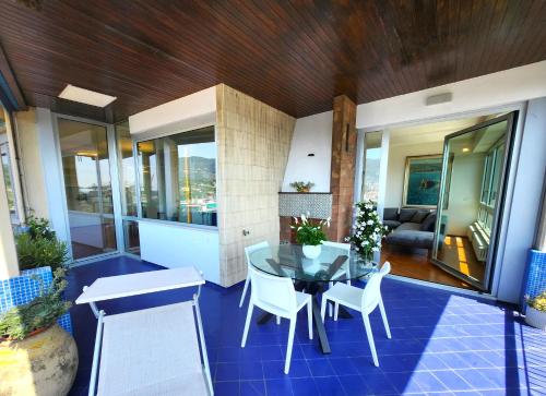 a house with a table and chairs on a patio at Appartamento Decimo Cielo Vista Mare in La Spezia