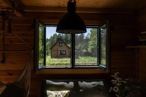 a window in a room with a view of a house at Głuszecki las in Skórcz
