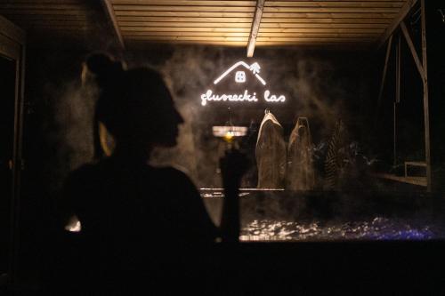 a woman standing in front of a store window at Głuszecki las in Skórcz