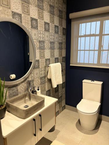 a bathroom with a sink and a toilet and a mirror at 51 Carrington Way in Kimberley
