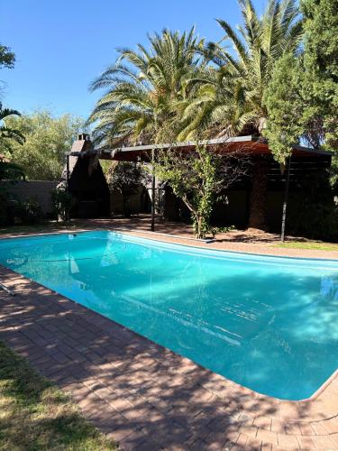 a blue swimming pool in front of a house at 51 Carrington Way in Kimberley
