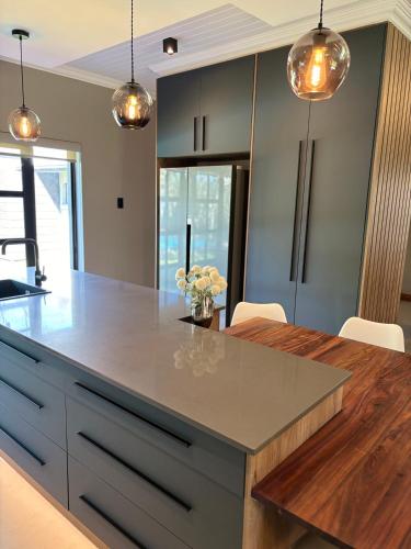 a kitchen with a large island with a counter top at 51 Carrington Way in Kimberley
