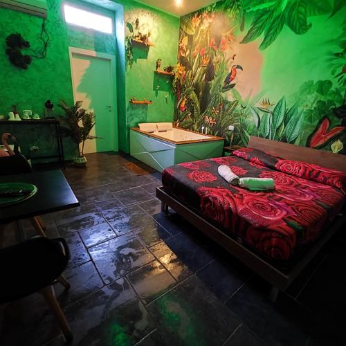 a bedroom with a bed and a bathroom with a tub at Suite Amazzonia in Taranto